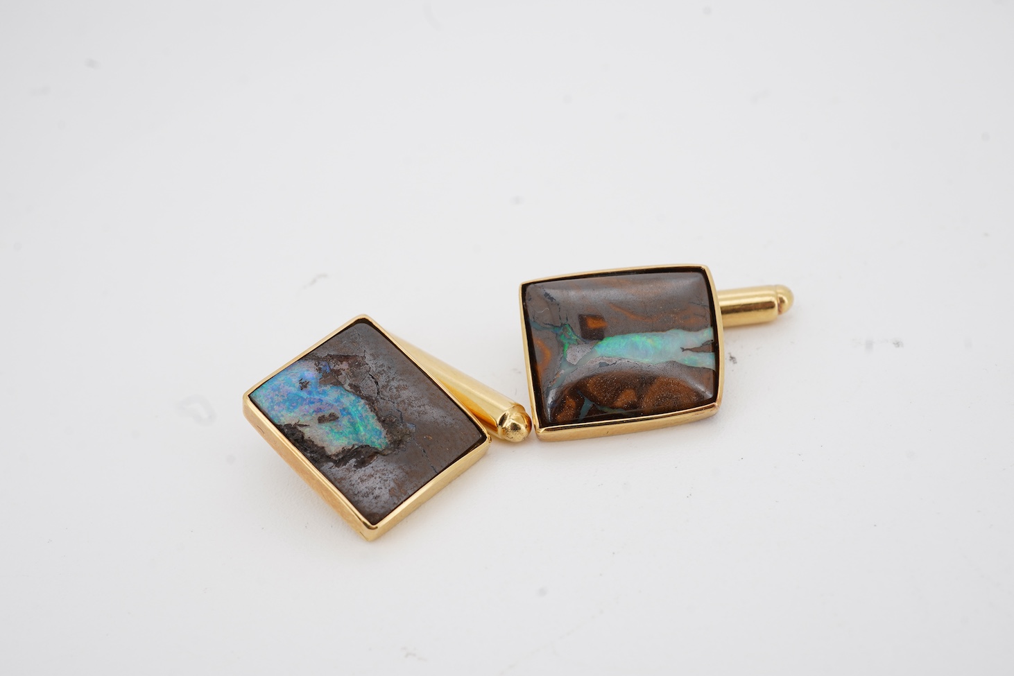 A modern pair of 18ct gold and opal set cufflinks by Geoffrey Turk Ltd, London, 13.5mm by 11mm, gross weight 7.8 grams, with original box.